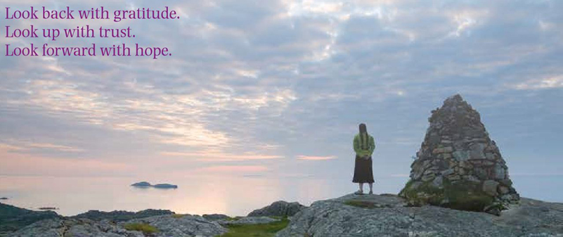 Woman, cairn, lake